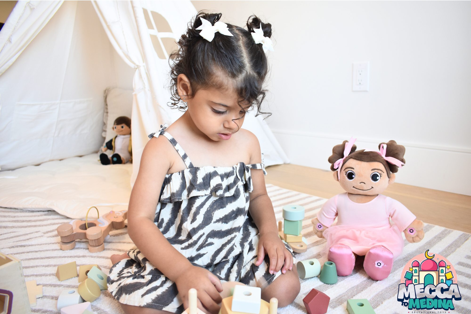 Child playing with toys in a room with Madina Islamic Teaching Doll. Cuddly Islamic doll Madina plush toy for kids learning Islam
