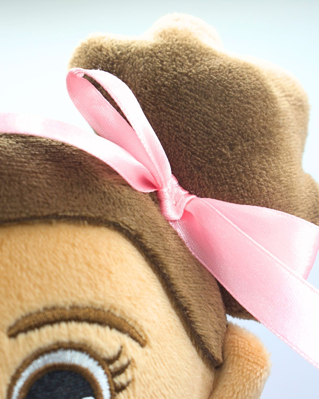 Doll close up go hair bun and bow. Cuddly Islamic doll Madina plush toy for kids learning Islam