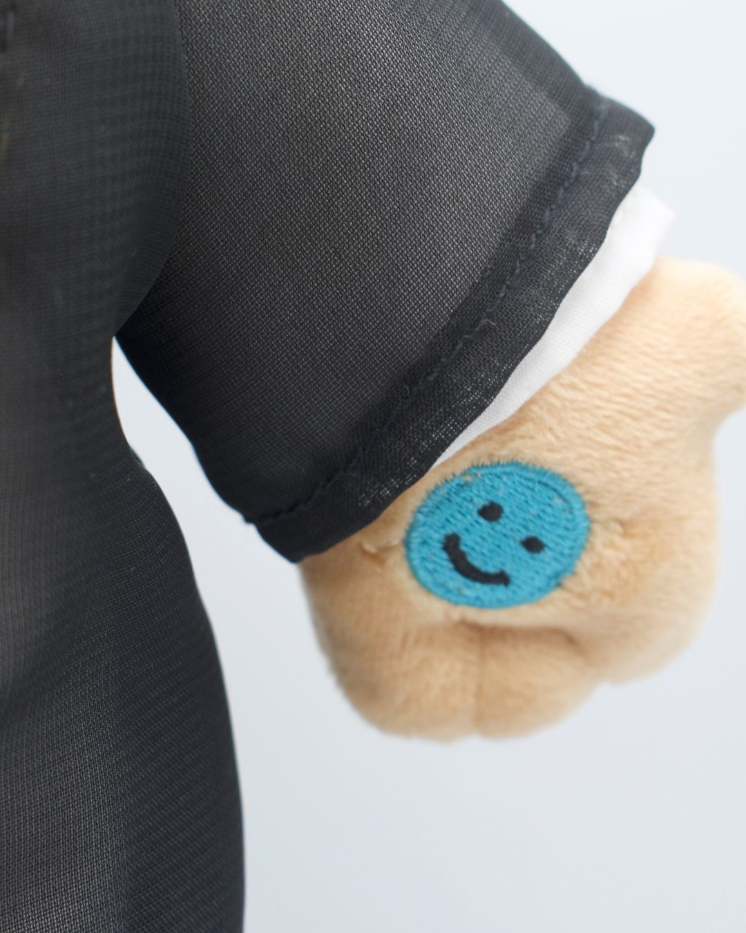 Doll Hand details. Soft Muslim plush doll wearing white shirt and jacket. Khaled toy teaching kids dhikr and nasheeds.