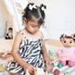 Child playing with toys in a room with Madina Islamic Teaching Doll. Cuddly Islamic doll Madina plush toy for kids learning Islam